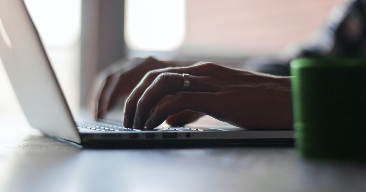 Close-up of person using a computer to calculate college costs