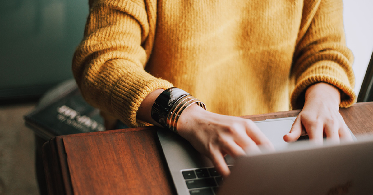 Woman researching how much to save for college on her computer