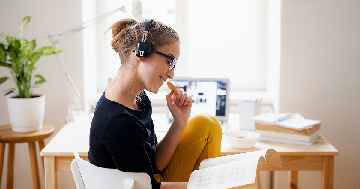 side view of woman sitting at computer