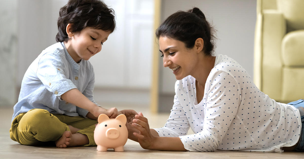 child and mom saving money in piggy bank