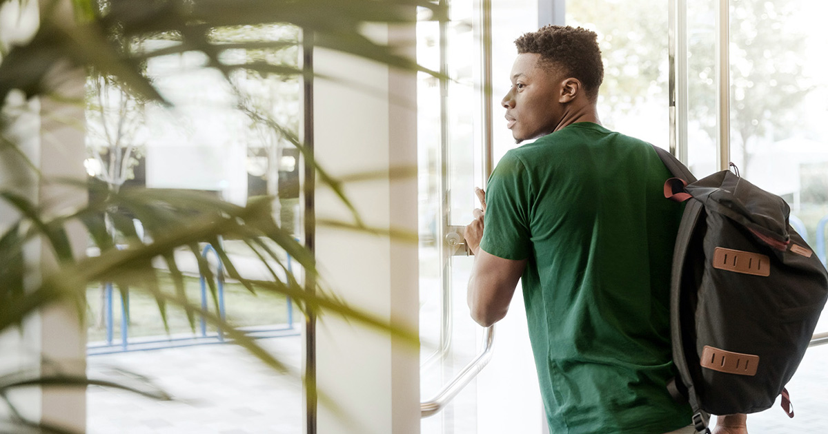 student opening college door